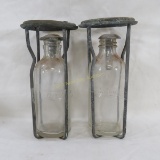 2 antique fire extinguisher bottles with cages