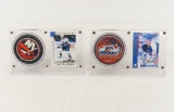 2 Autographed Hockey cards with pucks in displays