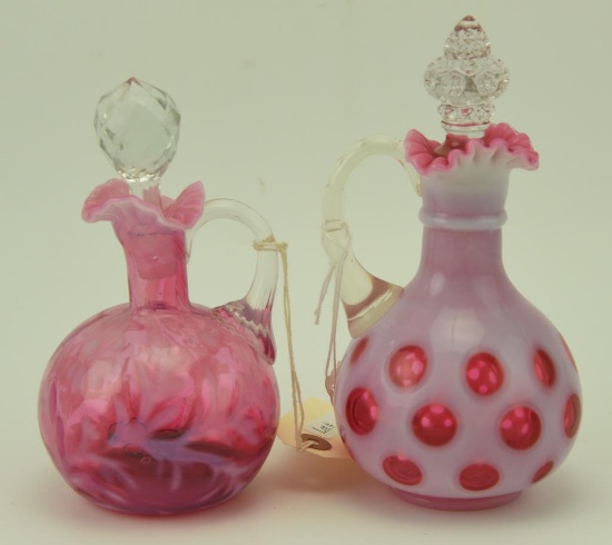Lot #44- (2) Fenton cranberry glass cruets in Fern optic and coin dot patterns, both have  stops