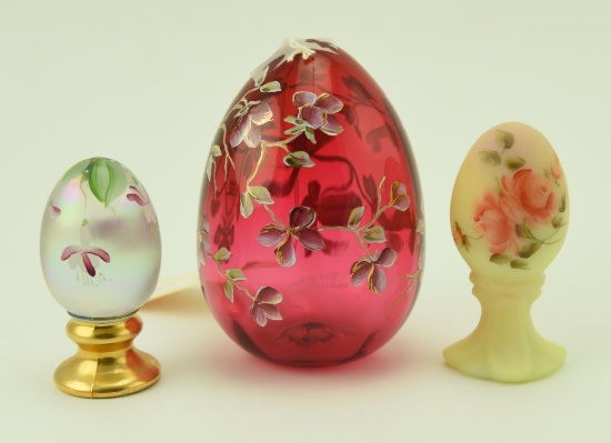Lot #47- (3) Fenton hand painted eggs to include: 5” Ruby glass hand painted by P.  Hayhurst,