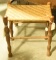 Lot 1554 - Turned wood stool with wicker seat (19” in height, 17” in width, and 12“ in depth)