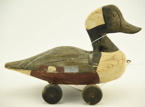 Lot 1440 - Carved & painted duck decoy pull toy on wooden wheels