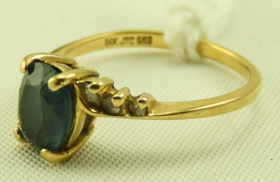 Lot 1637 - 14k gold ladies ring with blue center stone and clear stones on the side: weighs 1.6