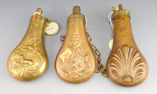 Lot #247 - (3) Antique brass paneled brass powder flasks: Bird dog and pheasant motif,  Scalloped