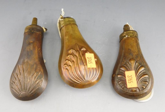 Lot #248 - (3) Antique brass shell pattern powder flasks (approx 4.5” each)