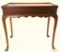 Lot #475 - Mahogany bench made rectangular tea top with raised edge, shaped skirt and Queen Anne