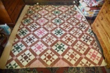 Lot #535 - Antique star pattern patchwork quilt with green pink and red designs (88” x 98”) in