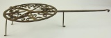 Lot #612 - Wrought Iron cooking Trivet with rotating top. 23” Long with 11.5” Diameter top