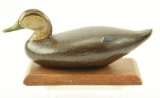 Lot #375 - Miniature carved Black Duck on platform by Ed Sampson (from the Mort Kramer Collection)