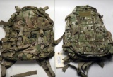 Lot #1114 - (2) Military style multi camo day pack backpacks. One marked US.