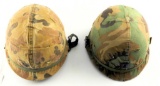 Lot #1463 - (2) Military helmets with multi camo covers. Both have liners