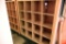 Lot #1272 - Contemporary natural finish 16 compartment storage case/bookcase (59” x 59” x 17”)