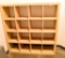 Lot #1277 - Contemporary natural finish 16 compartment storage case/bookcase (59” x 59” x 17”)