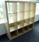 Lot #1430 - Contemporary natural finish 16 compartment storage case/bookcase (59” x 59” x 17”)