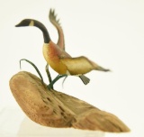 Lot #433 - Robert Phinney Maine, Full Body mi niature flying Canada Goose on driftwood signed