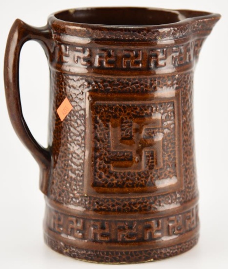 Lot #2339 - Antique Brown Salt Glaze Stoneware handled pitcher w/Good Luck Swastika. 11”good to