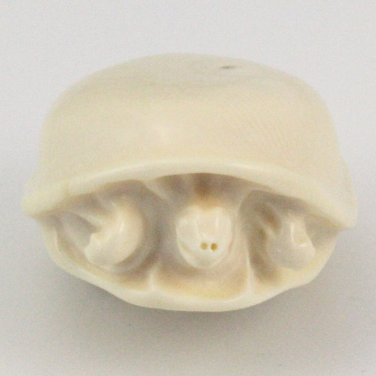 Genuine hand-carved ivory mushroom being eaten by a worm figurine