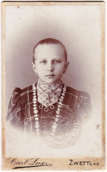 Embossed 1912 Austria identification card of a young girl in traditional dress