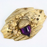 Vintage carved acorn design gilt pin with a purple stone