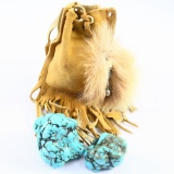 Pair of heavily-matrixed turquoise beads in a leather pouch