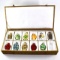 Collection of 11 Oriental snuff bottles in a plush hinged case
