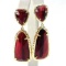 Pair of estate Kendra Scott yellow metal & red stone dangle earrings on earring card: post backs