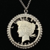 Genuine estate cut-out 1923 U.S. peace silver dollar in a white metal bezel with chain