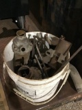 Bucket of miscellaneous items including carburetor and parts
