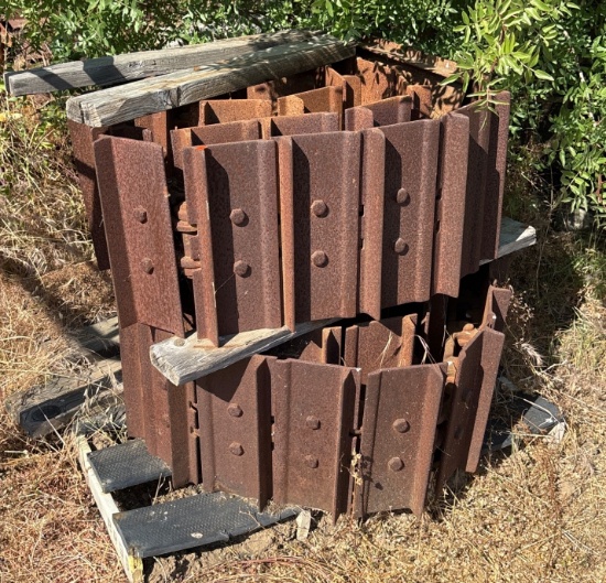Stack of Rusted Metal Track Sections