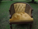 Padded living room chair with cane sides