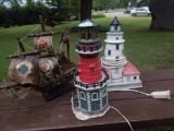 2 lighted light houses and a ship