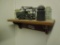 Wood shelf with bell truck, and 3 glass insulators