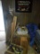 Misc on side wall, Blue tarp, 2 boxes of misc, wood cabinet with magazines, patriotic star