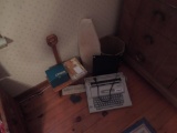 Typewriter, small tailors board, small bench, waste basket, wall hanging