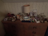 Contents only on top of long dresser, votive, lamp, figurines. apple, decor