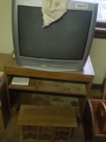 Magnavox TV with stand, cassette tape rack and box of misc