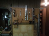 Contents of pegboard, levels, squared, table saw accessories