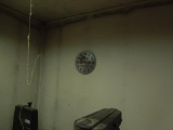 Shop clock, saw blades, clock, pictures in wall, man with boat, boat, criminals must register
