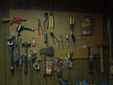 Contents on pegboard, hatchet, tin snips, 2 hand drills, hammer
