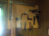Contents on peg board, levels, squares, old time tools, small cart and contents