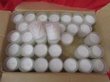 34 votive candles with glitter heart designs.