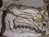 10+ assorted Gold and Silver tone Necklaces.