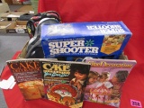 Box of Baking pans, decorating books, and super shooter