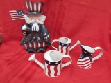 4th of july decorations. tin uncle sam. tin watering cans.