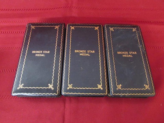 3 Bronze star medals in cases.
