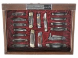 Group of Eighteen Folding Buck Knives with Display Case