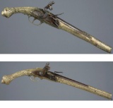 Two Ornate Balkan Style Metal Stocked Flintlock Pistols