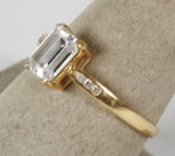 Gold colored ring with clear center stone; size 7.25