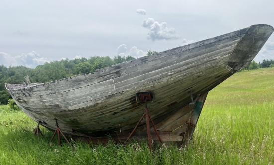 Older wood boat on stand