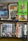 box of Paperback Military Books & VHS tapes